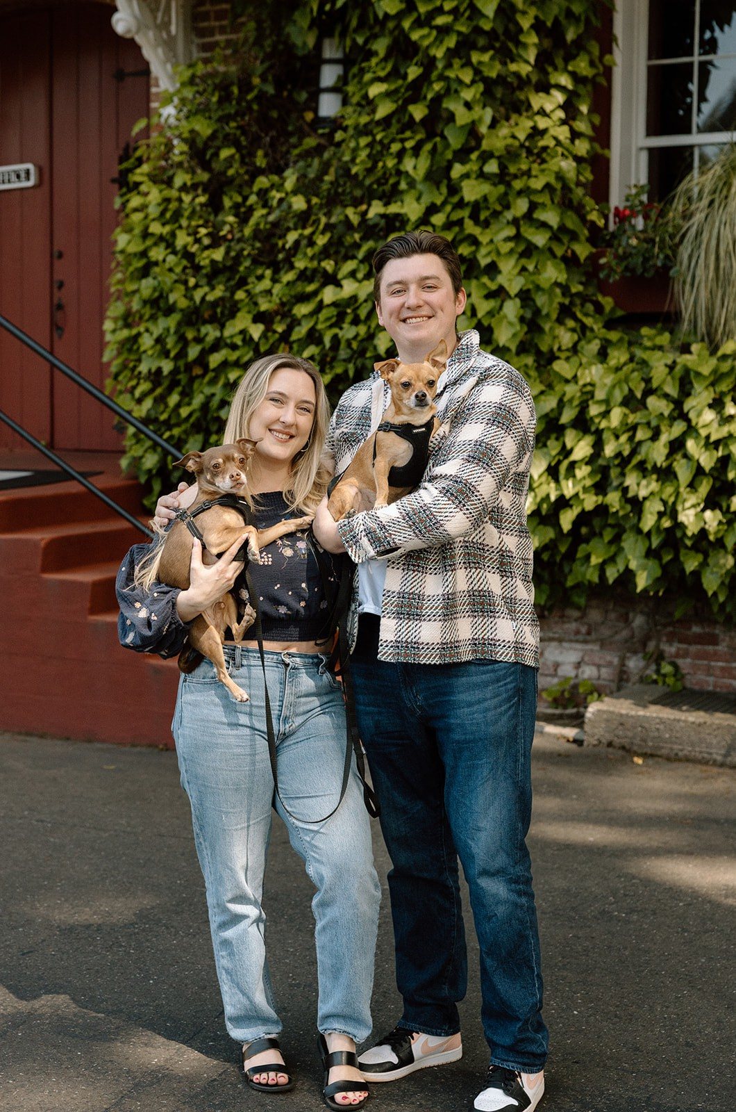 Vanessa and Cole outside Korbel, each holding one of their chihuahuas
